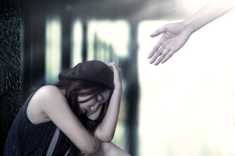 Women in need of addiction treatment, reaching out for a helping hand.